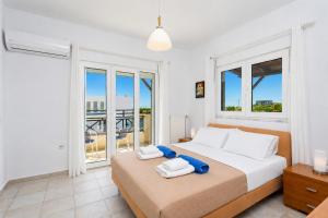 a bedroom with a large bed with towels on it at Hermione Villa in Gennadi +16 photos