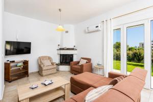 a living room with a couch and a fireplace at Hermione Villa in Gennadi