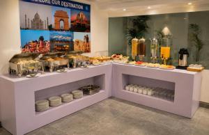 a bakery with a buffet of food on display at Hotel Pinky Villa-Heritage Boutique Suites Near New Delhi Train station & Connaught place in New Delhi