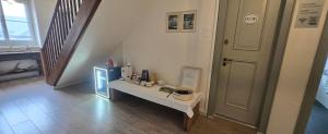 a hallway with a white table and a door at B&B Langenberg in Langnau am Albis