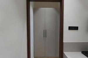 a white cabinet in a room with a wall at 7 Pearls in Gajendragarh