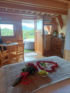 a room with a bed with a bowl of fruit on it at Glamping Čelig in Donja Višnjica
