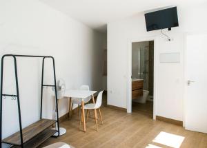a room with a table and a mirror at A Calexa Sarria nº1 in Sarria