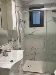 a bathroom with a sink and a shower with a television at Casaxxvaprile in Turin
