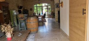 a room with two wine barrels and a table at La Remise in Vergèze