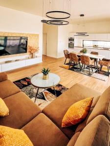 a living room with a couch and a table at Alexandra Nesvady in Nesvady
