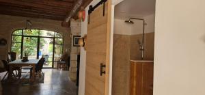a kitchen and dining room with a table and a door at La Remise in Vergèze