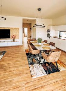 a kitchen and dining room with a table and chairs at Alexandra Nesvady in Nesvady