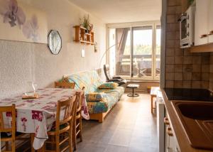 a living room with a table and a couch at Studio avec vue sur la montagne à Villard de Lans - 34 m² in Villard-de-Lans