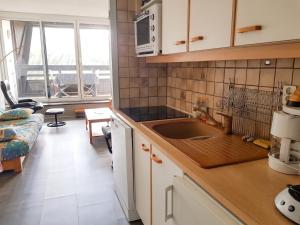 a kitchen with a sink and a living room at Studio avec vue sur la montagne à Villard de Lans - 34 m² in Villard-de-Lans