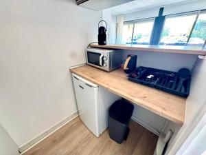 a kitchen with a counter with a microwave on it at Reflet d’Azur - 4 personnes - Point zéro in La Grande Motte