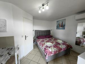 a bedroom with a bed with a purple bedspread at Countryside Studio Apartment Valentina in Vrh