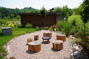 a group of tree stump stools in a garden at Pod křídly Krkonoš in Černý Dŭl
