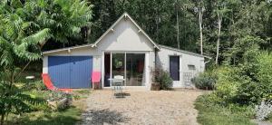 a small house with a blue and white garage at Le bois des Mottouses in Pellouailles-les-Vignes +2 photos