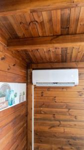 a room with wooden walls and a ceiling at Maison cosy avec piscine partagée à Capesterre-Belle-Eau in Besnard