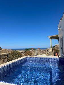 a swimming pool with a view of the ocean at Paros Sunset Villas PSV & PSV2 in Parikia