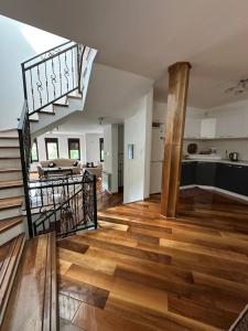 a living room with a staircase and a kitchen at Prestige Old Town Villa in Sarajevo