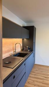 a kitchen with a sink and a counter top at Ferienwohnung Lisa in Grabenstätt +2 photos