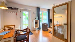 a kitchen and dining room with a table and a mirror at Captain Pahlen Ferienanlage in Zingst