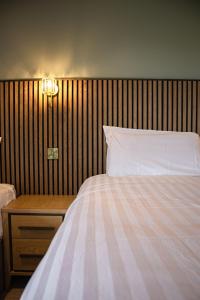 a bedroom with a bed with a wooden head board at Canavans Hotel in Garvaghy