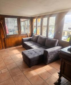 a living room with a couch and some windows at Spacious House in Canejan with Mountain View in Caneján