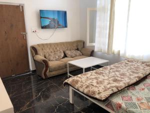 a living room with a couch and a table at JIJIVISHA Homestay in Bhīm Tāl
