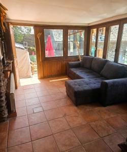 a living room with a couch and some windows at Spacious House in Canejan with Mountain View in Caneján