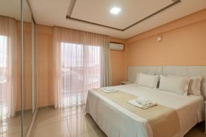 a bedroom with a large bed and a large window at Pousada D' Areia in Barreirinhas +37 photos