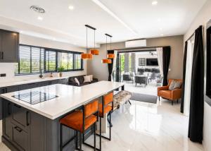 an open kitchen and living room with a large island at Grey Stones Villa by HolidayKeys in Kyrenia