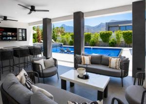a living room with couches and a swimming pool at Grey Stones Villa by HolidayKeys in Kyrenia