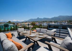 a patio with a table and chairs on a roof at Grey Stones Villa by HolidayKeys in Kyrenia