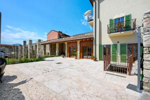 an empty courtyard of a house with a building at Al Casel - Appartamento Collina in Torri del Benaco