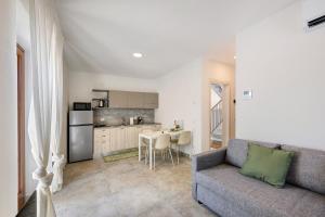 a living room with a couch and a kitchen at Al Casel - Appartamento Collina in Torri del Benaco