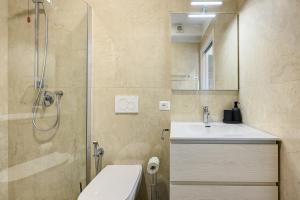 a bathroom with a toilet and a sink and a shower at Al Casel - Appartamento Collina in Torri del Benaco +16 photos