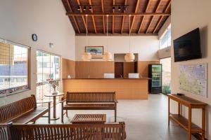 a waiting room with benches and a counter at Pousada D' Areia in Barreirinhas