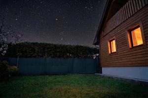 a night view of a house with the stars in the sky at Chata pri Kaštieli - 2 E-bikes in Necpaly