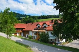 a row of houses with red roofs on a road at Ferienhof Pfaffenlehen in Maria Neustift