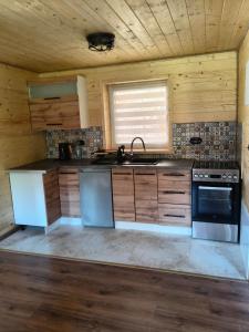 a kitchen with a sink and a stove at Domek MAGELLAN Cisna 11 in Cisna