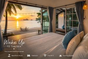 a bedroom with a bed with a view of the ocean at Villa Sea view in Ko Phi