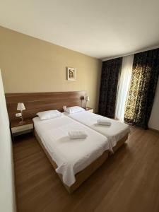 a bedroom with a large bed with two towels on it at Hotel BlueTwo Međugorje in Međugorje +13 photos