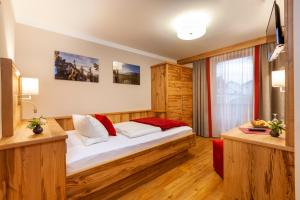 a hotel room with a bed and a window at Genusshotel Hohenbogen GARNI in Neukirchen beim Heiligen Blut +32 photos