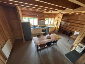 an overhead view of a kitchen with a table and chairs at Golden Nest in Courteranges +4 photos