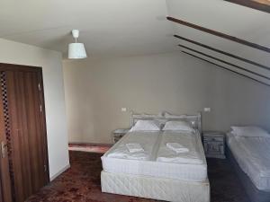 a bedroom with a bed in the corner of a room at Casa Bradul Inalt in Sohodol