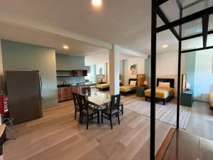 a living room with a table and chairs and a bedroom at Apartment with Pool & Gym in Querétaro