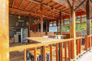 a large room with wooden tables in a building at Balian Jus in Tuktuk Siadong