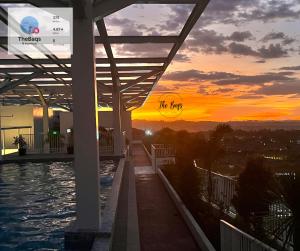 a view of the city at sunset from a building at Marvel Fan Studio Condo with Pool CDO TheBaqs in Balulang