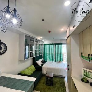 a bedroom with a bed and a couch at Marvel Fan Studio Condo with Pool CDO TheBaqs in Balulang
