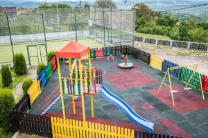 a playground with a play structure on a tennis court at Casa Bradul Inalt in Sohodol
