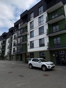 a white car parked in front of a building at Family 30 in Lutsk