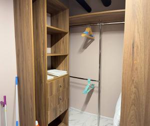 a walkin closet with a glass shower in a bedroom at Family 30 in Lutsk